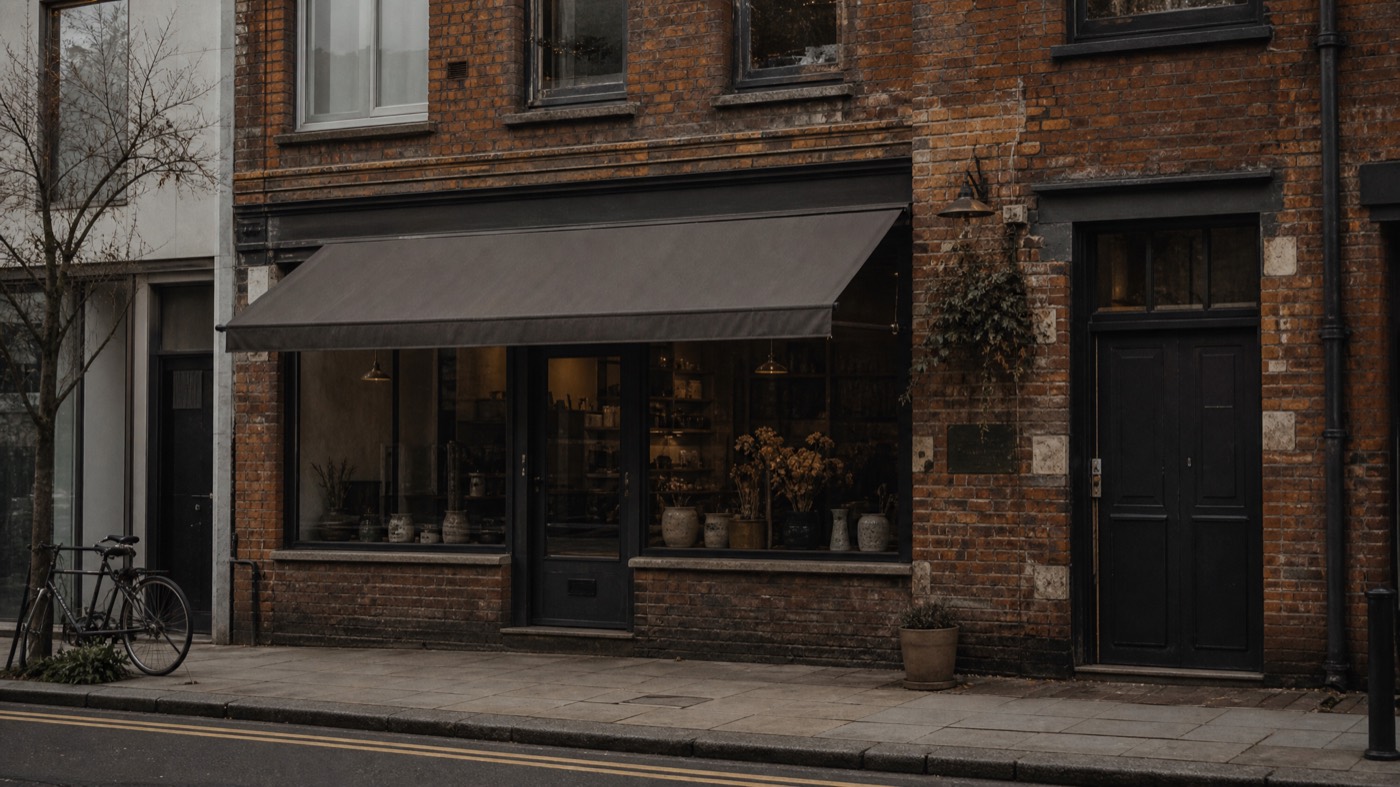 Real small shopfront on a high street, showing a genuine staffed physical location Google can verify